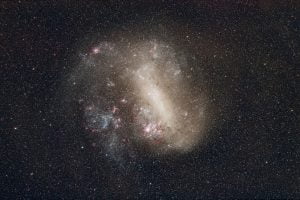 The Large Magellanic Cloud photographed using a small telephoto lens and a modified DSLR camera to highlight the red HII molecular clouds. Credit: Andrew Lockwood.