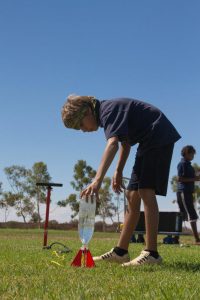 A Meekatharra DHS student carefully preparing their water rocket for launch