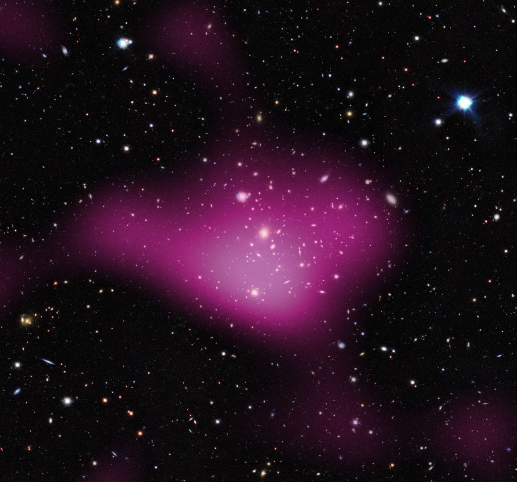 First Results from the KiDS Survey (dark matter). Invisible dark matter is seen rendered in pink on top of the visible-light image. Credit: Kilo-Degree Survey Collaboration/A. Tudorica & C. Heymans/ESO