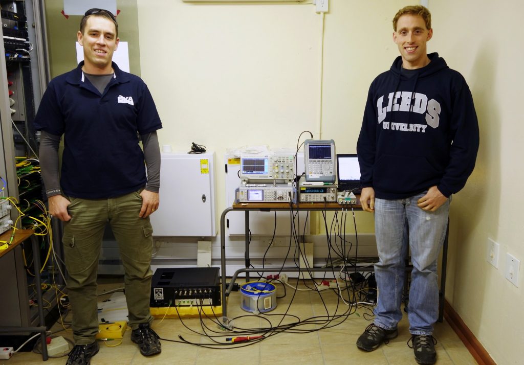 SASCHA SCHEDIWY (LEFT) AND DAVID GOZZARD IN FRONT OF THE FREQUENCY SYNCHRONISATION SYSTEM.