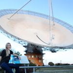 Jacinta Delhaize with CSIRO's Parkes Radio Telescope during one of her data collecting trips. Credit: Anita Redfern Photography.