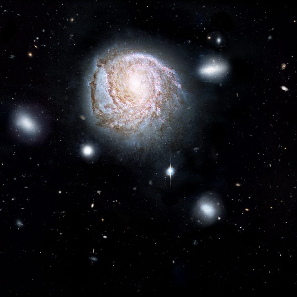 This artist's impression shows the spiral galaxy NGC 4921 based on observations made by the Hubble Space Telescope. Credit: ICRAR, NASA, ESA, the Hubble Heritage Team (STScI/AURA)