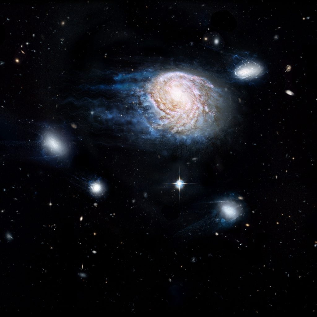 An artist’s impression of ram-pressure stripping of galaxy NGC 4921. Stripping removes gas—the raw fuel for star formation—and could be the dominant way galaxies are killed by their environment. Credit: ICRAR, NASA, ESA, the Hubble Heritage Team (STScI/AURA)