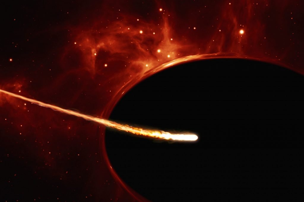 This artist’s impression depicts a Sun-like star close to a rapidly spinning supermassive black hole, with a mass of about 100 million times the mass of the Sun, in the centre of a distant galaxy. Its large mass bends the light from stars and gas behind it. Despite being way more massive than the star, the supermassive black hole has an event horizon which is only 200 times larger than the size of the star. Its fast rotation has changed its shape into an oblate sphere. The gravitational pull of the supermassive black hole rips the the star apart in a tidal disruption event.In the process, the star was “spaghettified” and shocks in the colliding debris as well as heat generated in accretion led to a burst of light. Credit: ESO, ESA/Hubble, M. Kornmesser