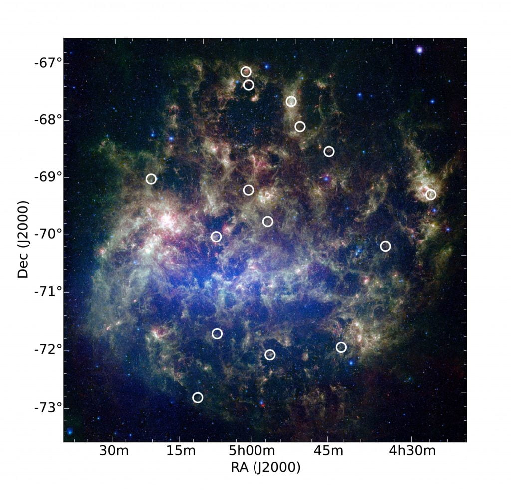This image from NASA's Spitzer Space Telescope features the Large Magellanic Cloud, a satellite galaxy to our own Milky Way galaxy. Overlaying the image are circles showing the locations of 15 star clusters where multiple generations of stars have been discovered. Credit: Karl Gordon and Margaret Meixner - Space Telescope Science Institute/AURA/NASA. Compilation by Bi-Qing For and Kenji Bekki (ICRAR/UWA).