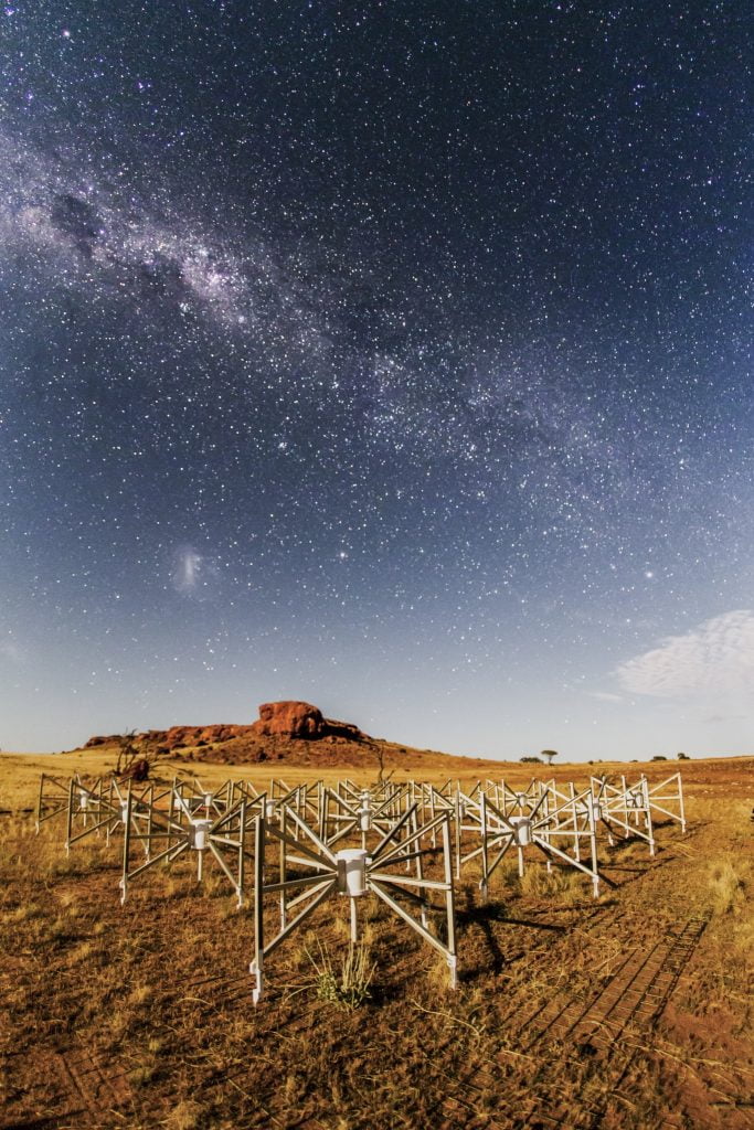 Tile 107, or “the Outlier” as it is known, is one of 256 tiles of this SKA precursor instrument located 1.5km from the core of the telescope. Lighting the tile and the ancient landscape is the Moon. Photographed by Pete Wheeler, ICRAR.