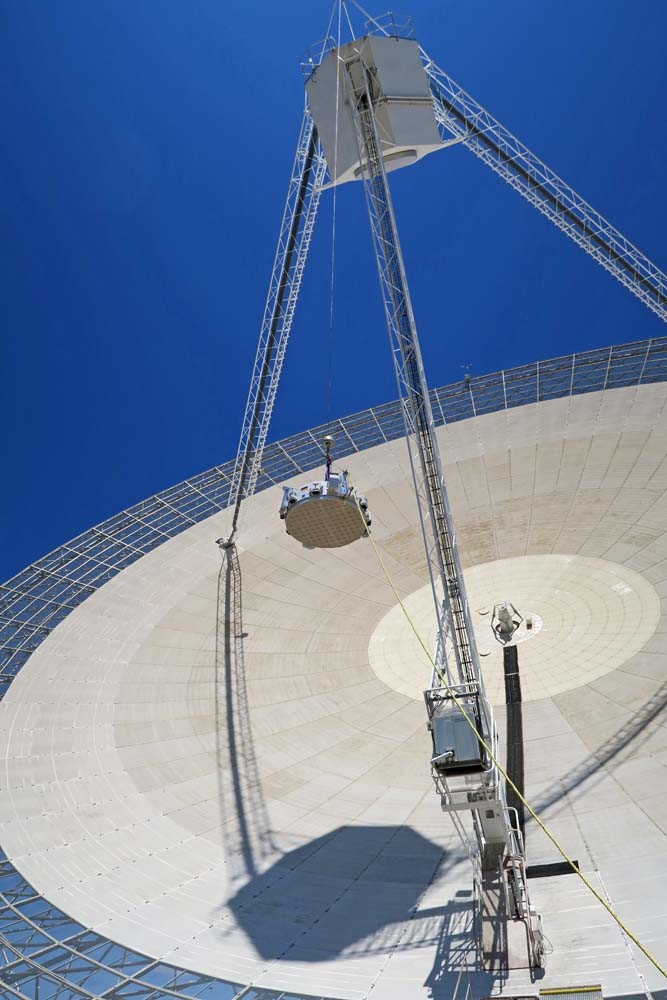 The phased-array feed built for Germany’s Effelsberg telescope being lifted into CSIRO’s Parkes telescope for commissioning tests. Credit: John Sarkissian