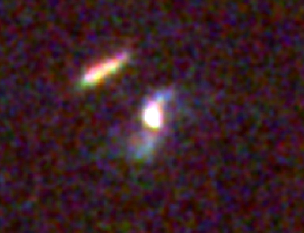Hubble image (HST_3-colour_GRB190114C_host_labels.jpg): The fading afterglow of GRB 190114C and its home galaxy were imaged by the Hubble Space Telescope on Feb. 11 and March 12, 2019. The difference between these images reveals a faint, short-lived glow located about 800 light-years from the galaxy’s core. Blue colours beyond the core signal the presence of hot, young stars, indicating that this is a spiral galaxy somewhat similar to our own. It is located about 4.5 billion light-years away in the constellation Fornax. Credit: NASA, ESA, and V. Acciari et al. 2019
