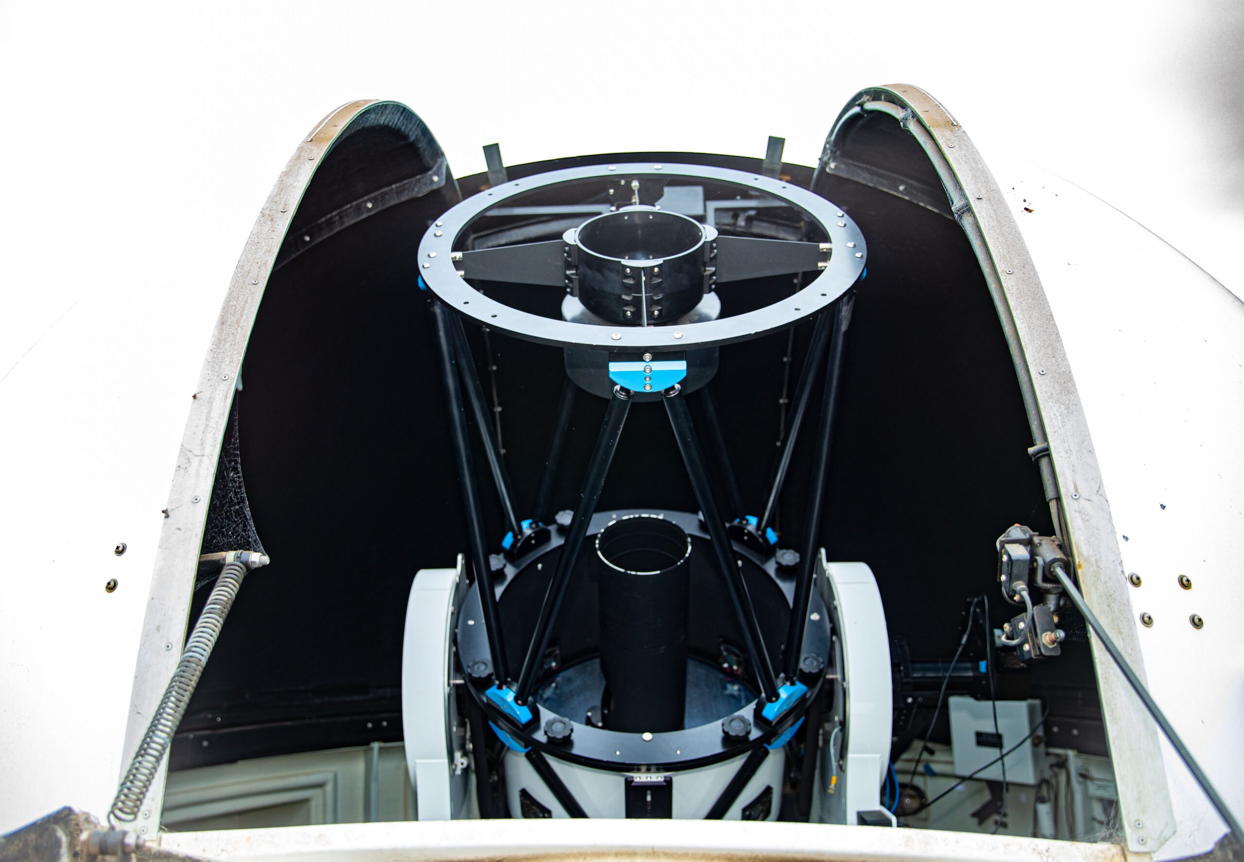 An optical comms terminal peeks out of an observatory-style dome.