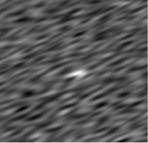 A white blob against a blurry black and grey background