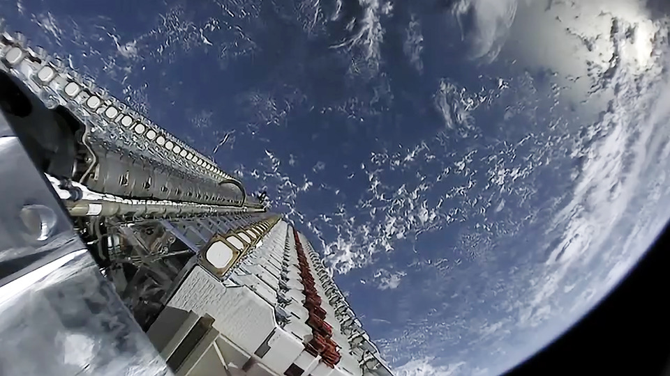 A full payload of Starlink Satellites ready for deployment above the Earth.